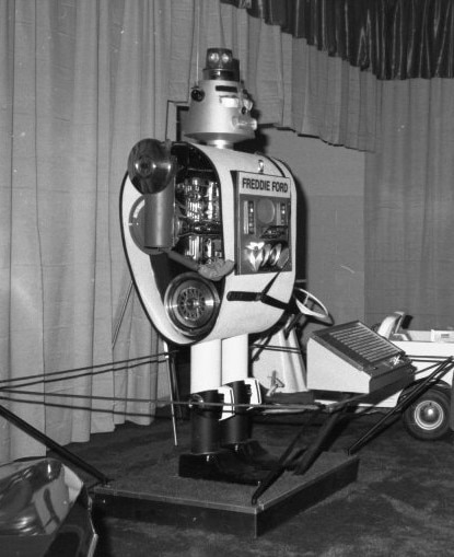 A black and white photo of Freddie Ford, a 9-foot-tall robot built from Ford car parts